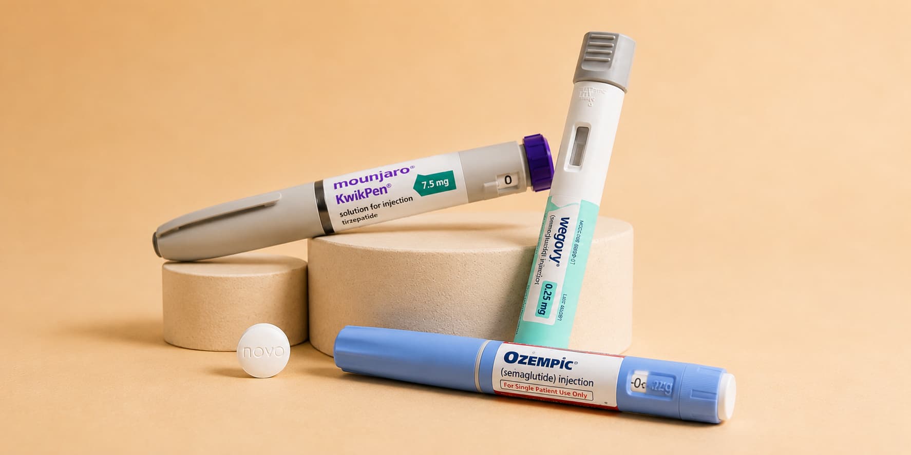 GLP-1 injection pens from Mounjaro, Wegovy and Ozempic with a tablet beside them